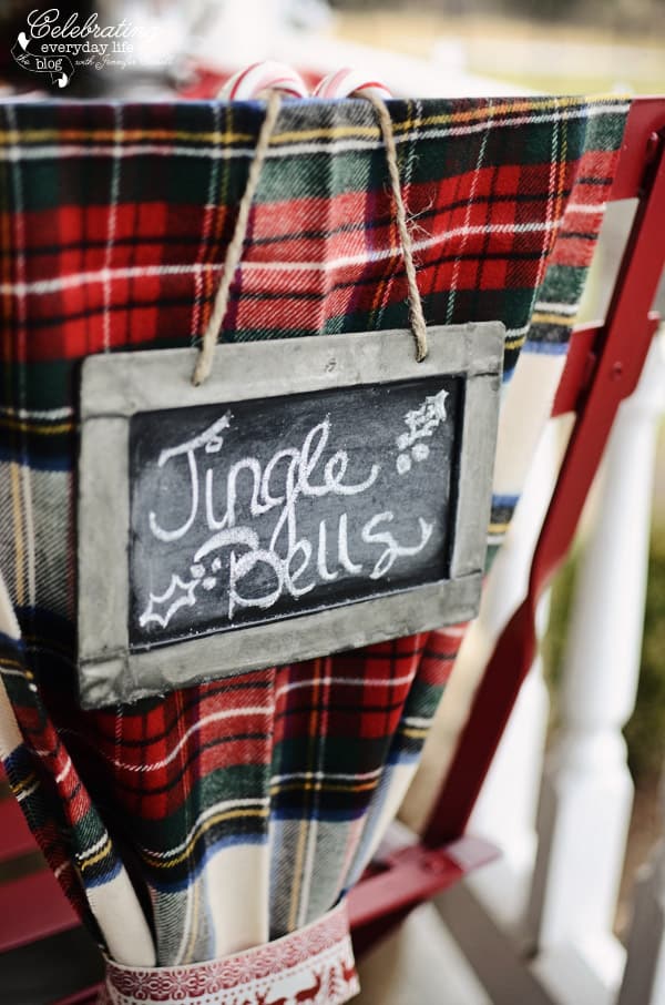 Jingle Bells chalk sign, plaid scarf chair decor, hot cocoa front porch party